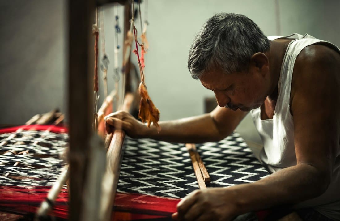 A weaver working at a handloom