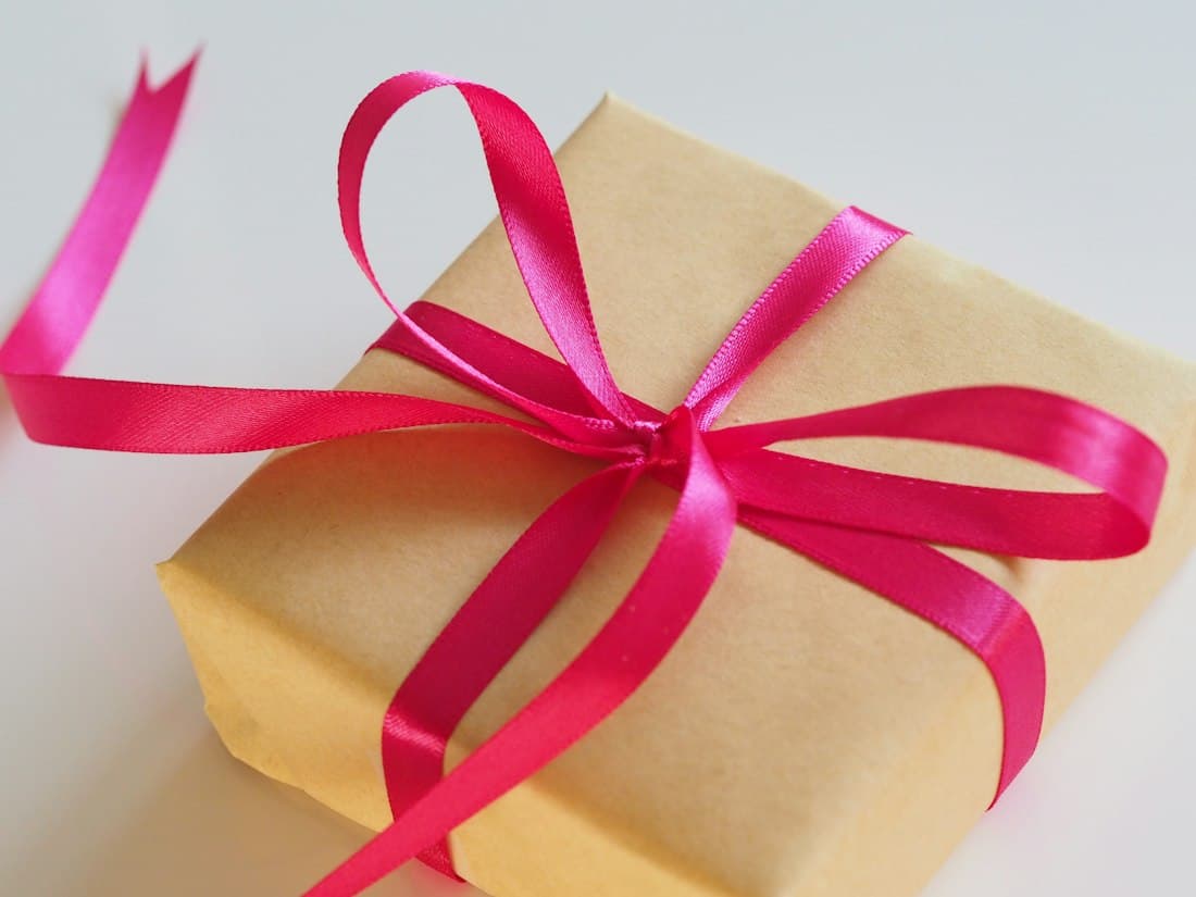 A wrapped gift box with a bright ribbon