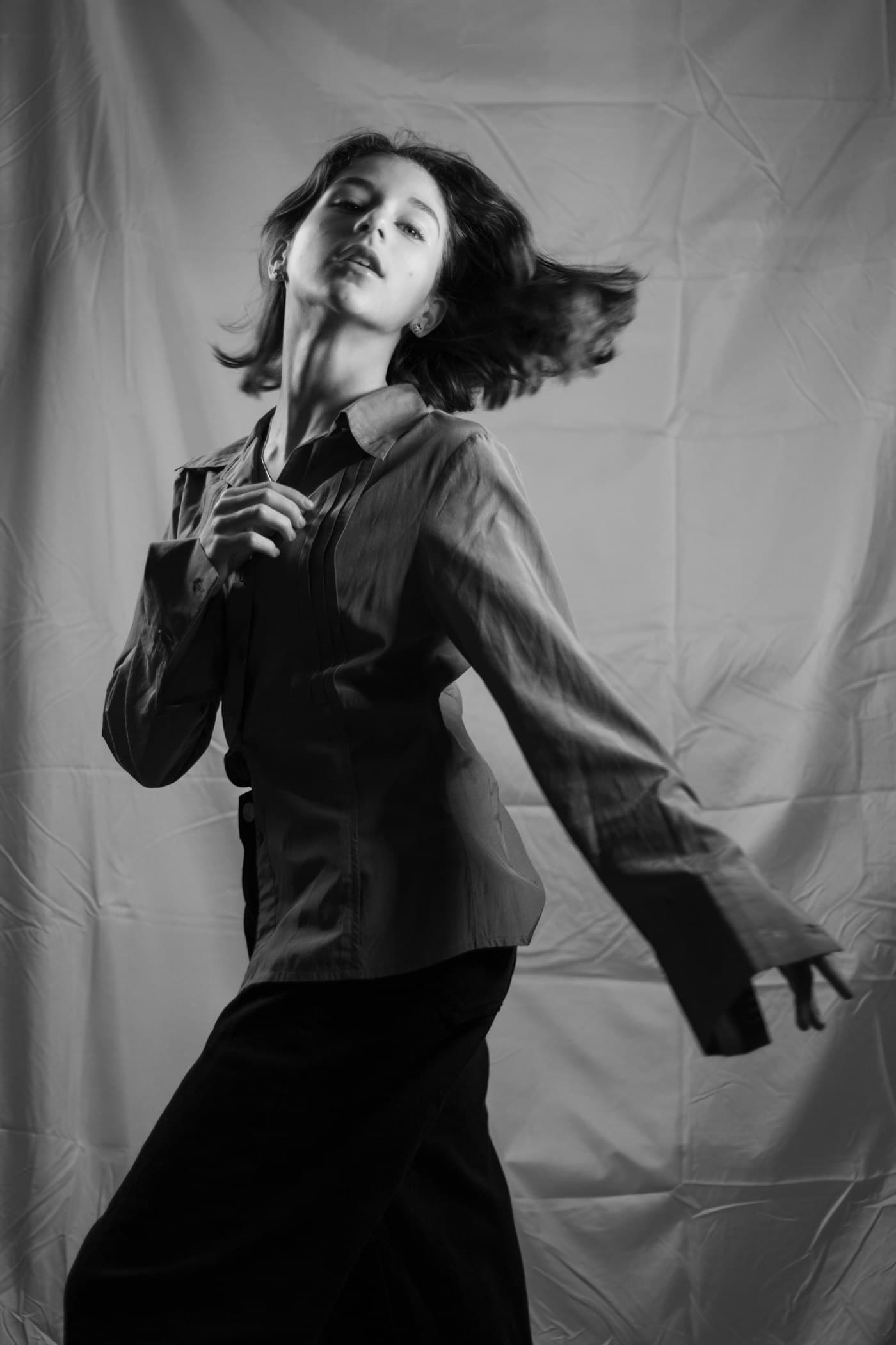 Monochrome portrait of a model in a dark shirt in motion