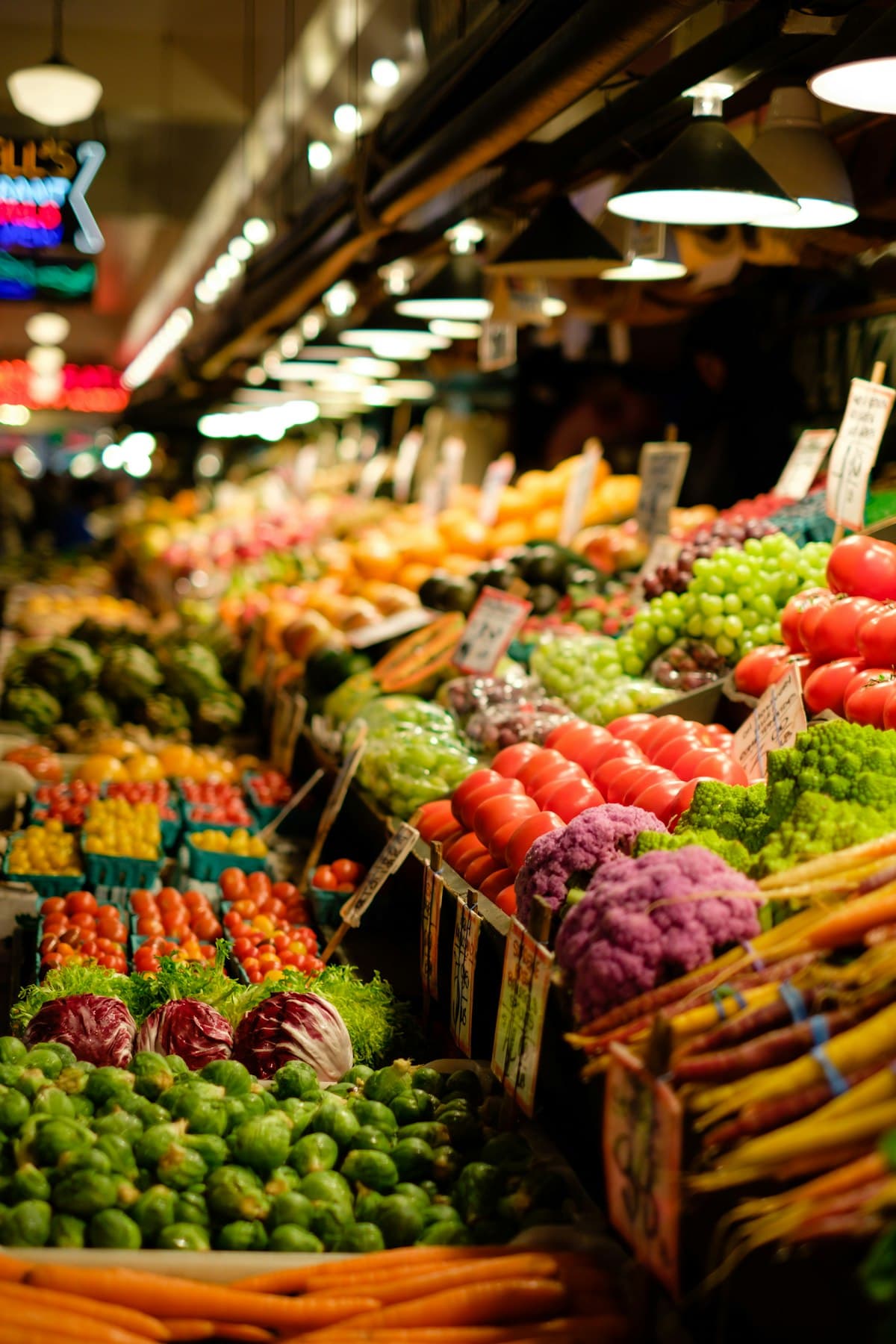 A supermarket produce aisle with neatly stacked vegetables