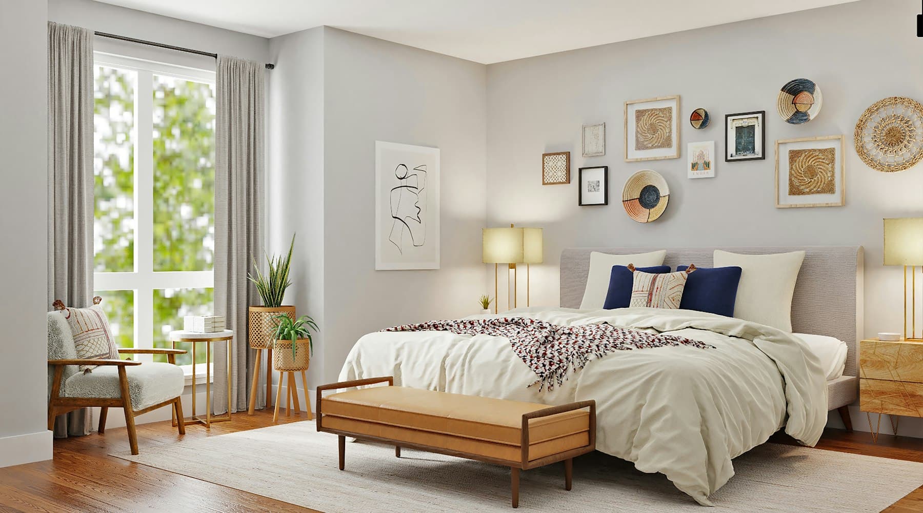 Bright bedroom with a layered bed, armchair and framed prints