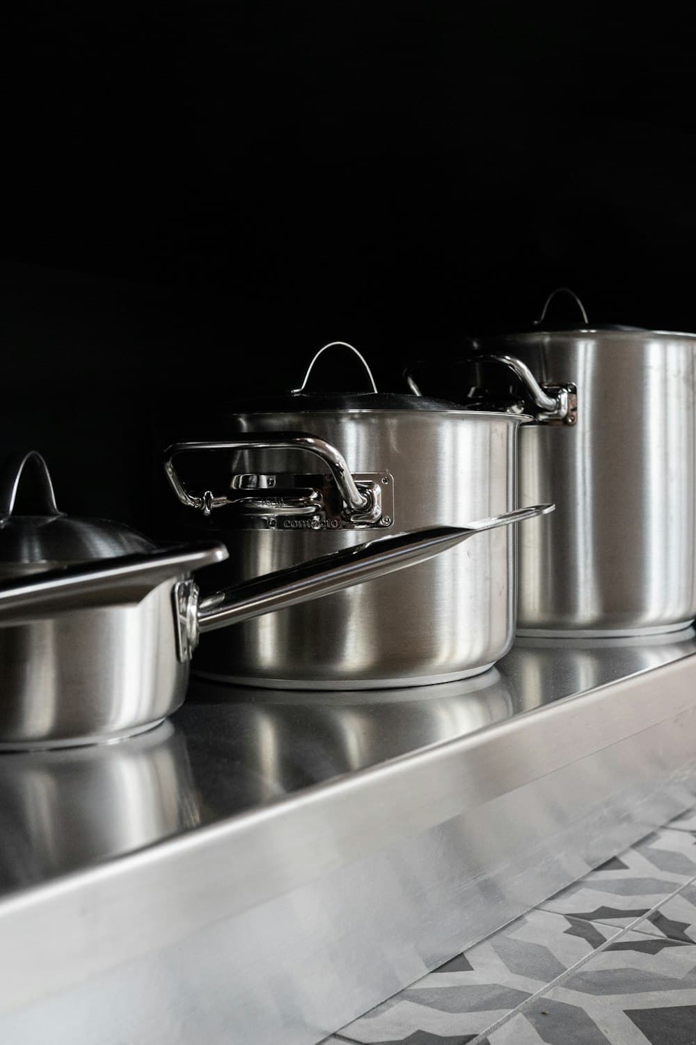 Stainless steel pots on a steel counter