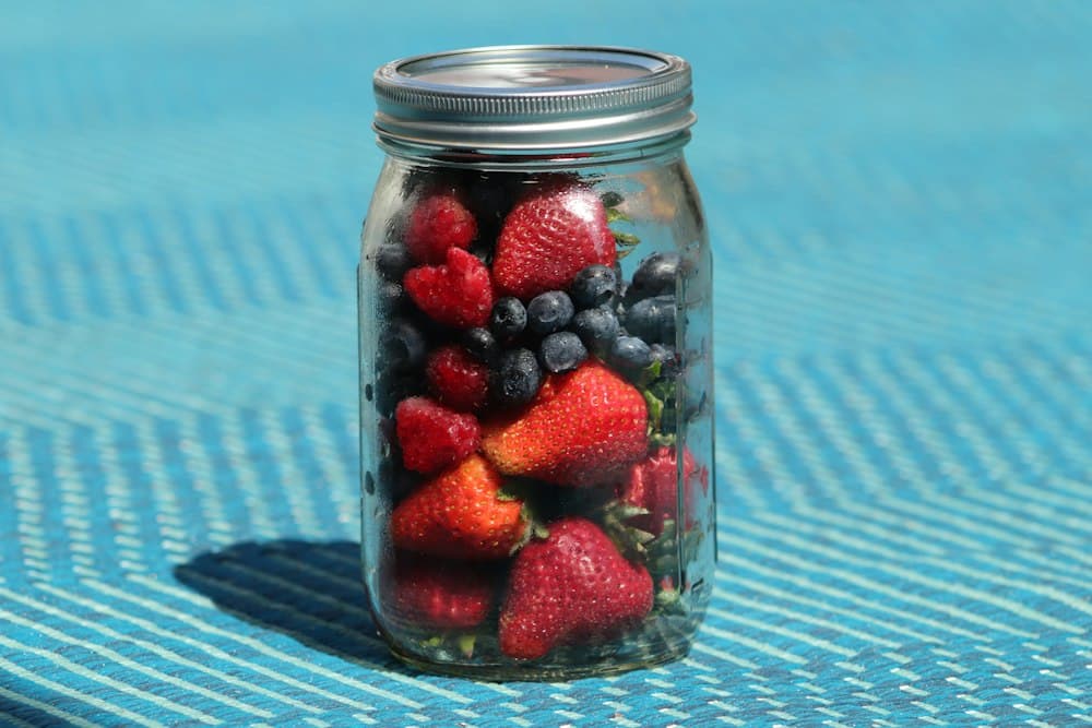 Glass jar packed with fresh berries