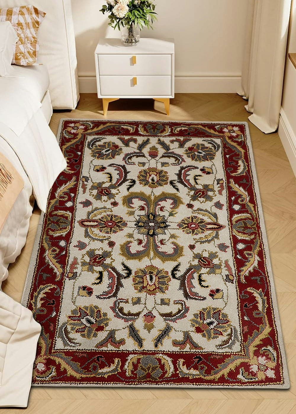Patterned rug beside a bedside table