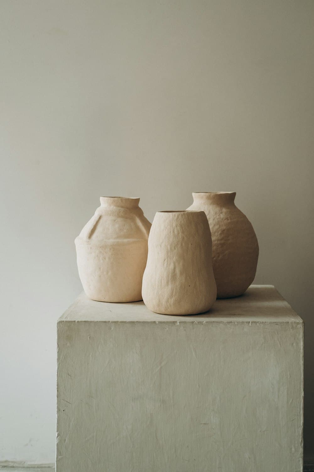 Matte stoneware vases on a plaster block